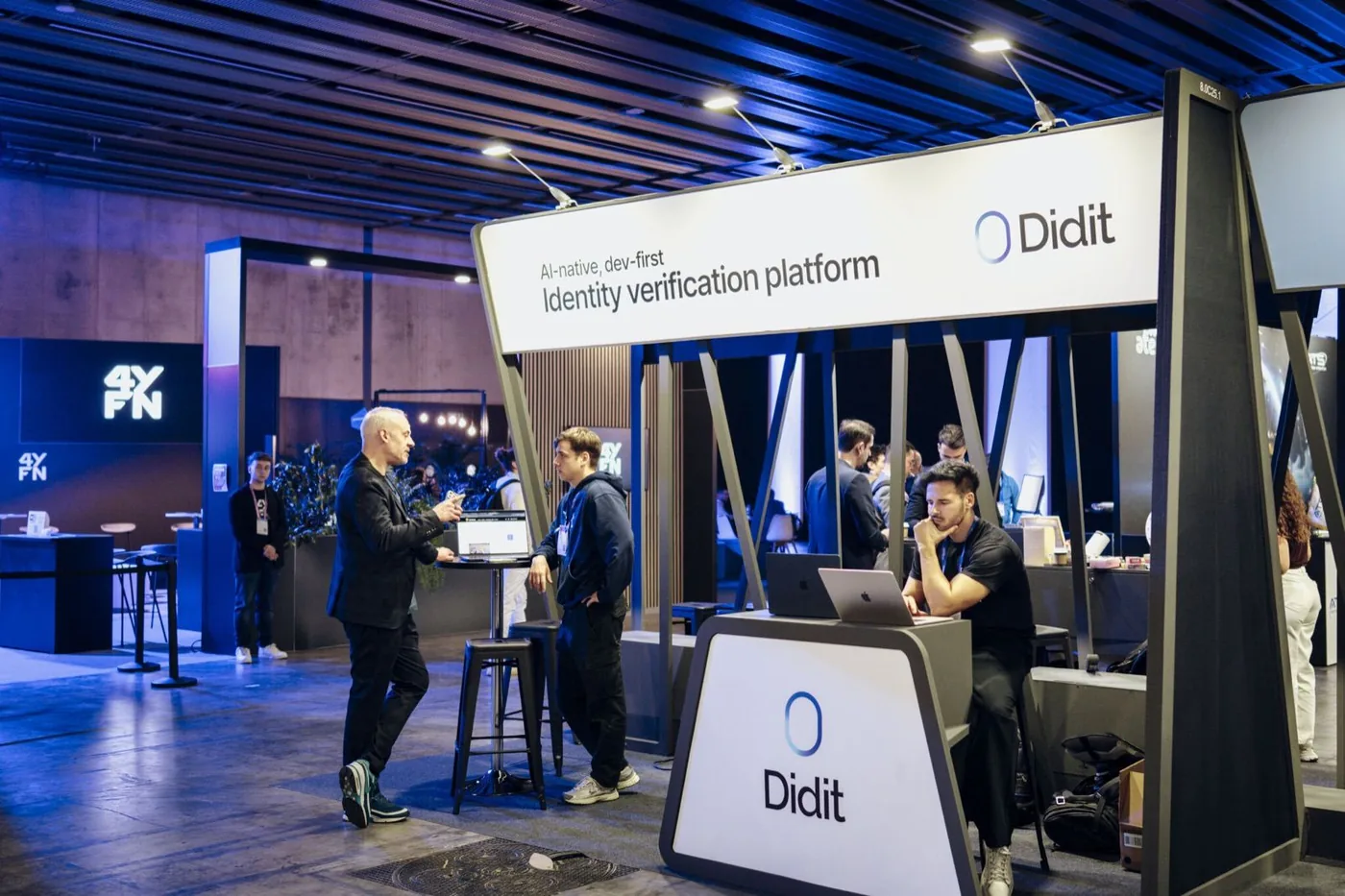 The Didit stand at a trade show, with the team talking to visitors