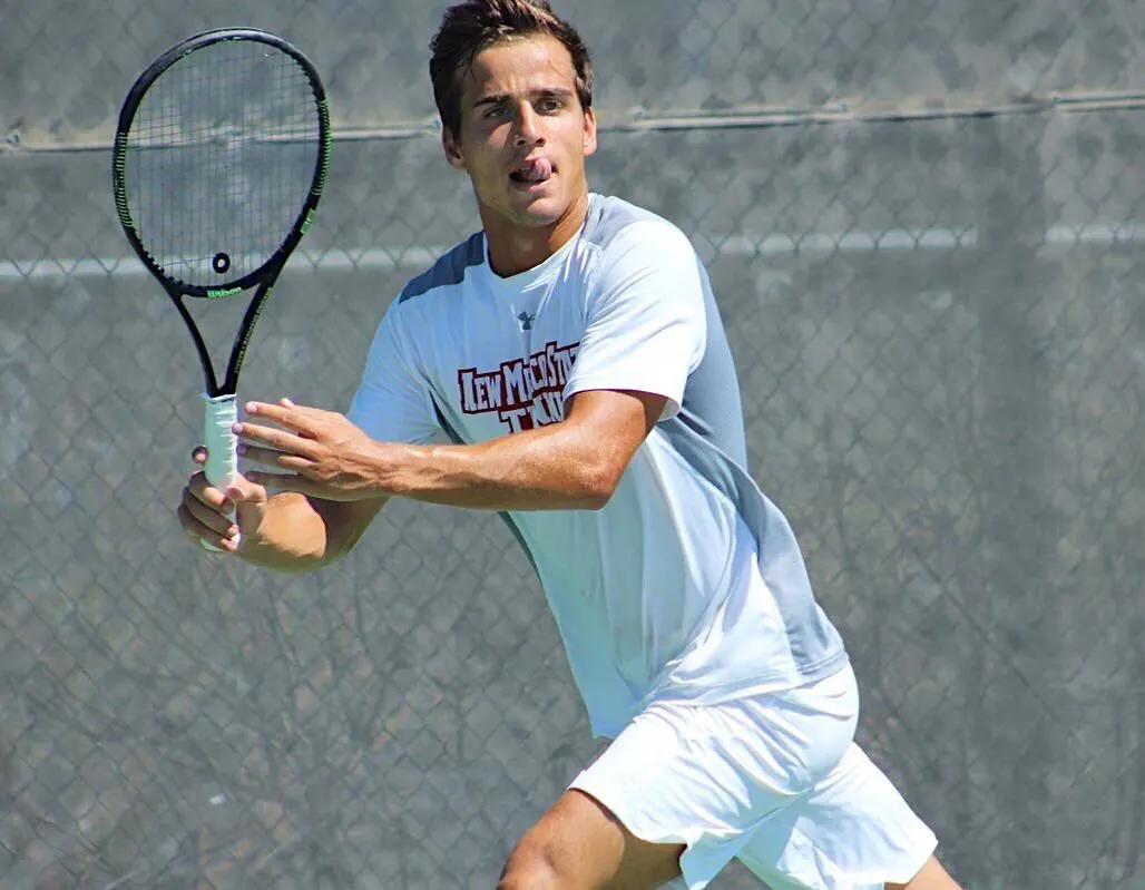 Alejandro hitting a forehand on court in a New Mexico State shirt