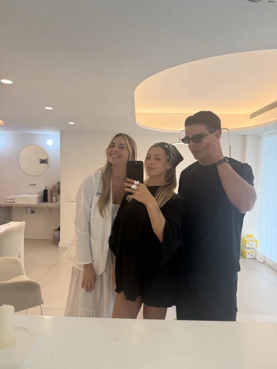 Alejandro with two members of the team in a Santé clinic mirror