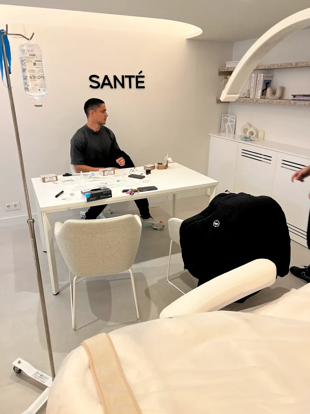 Alejandro at a desk in a white Santé consultation room